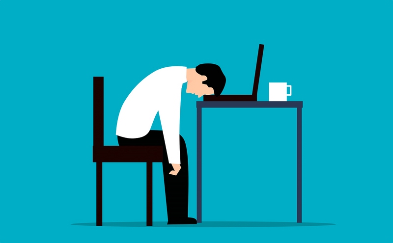 Illustration: erschöpfter Mann legt Kopf auf Schreibtisch